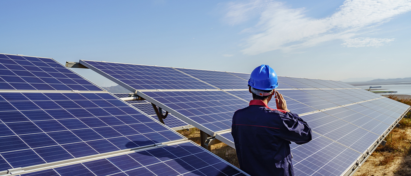 Worker in front of solar energy panels