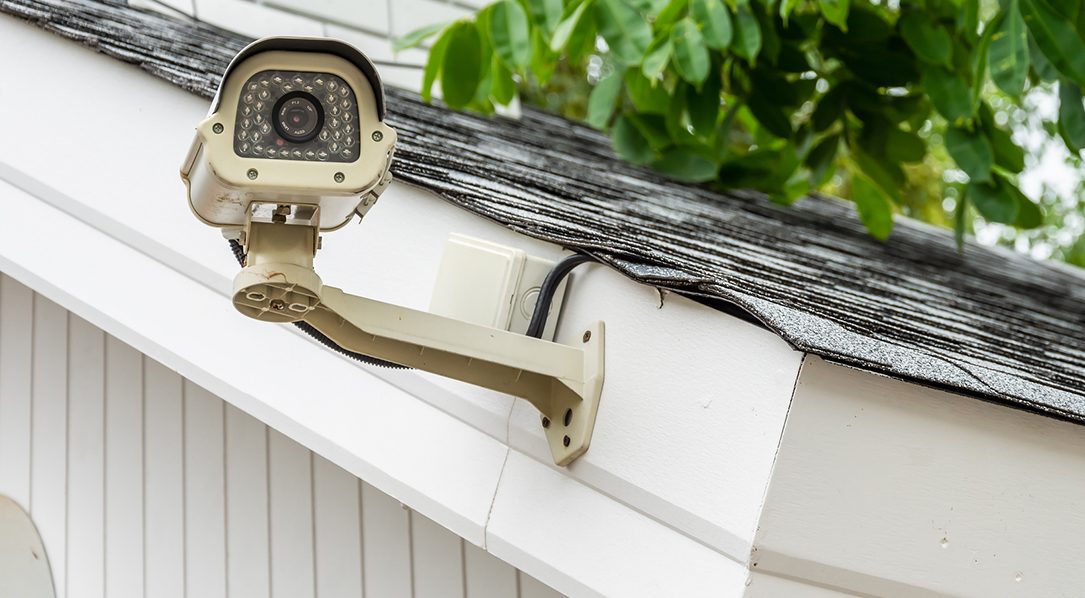 Surveillance camera on the side of a house