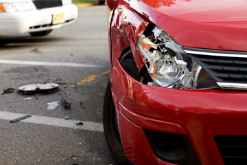 Close up photo showing damage to the headlight of a car during a crash