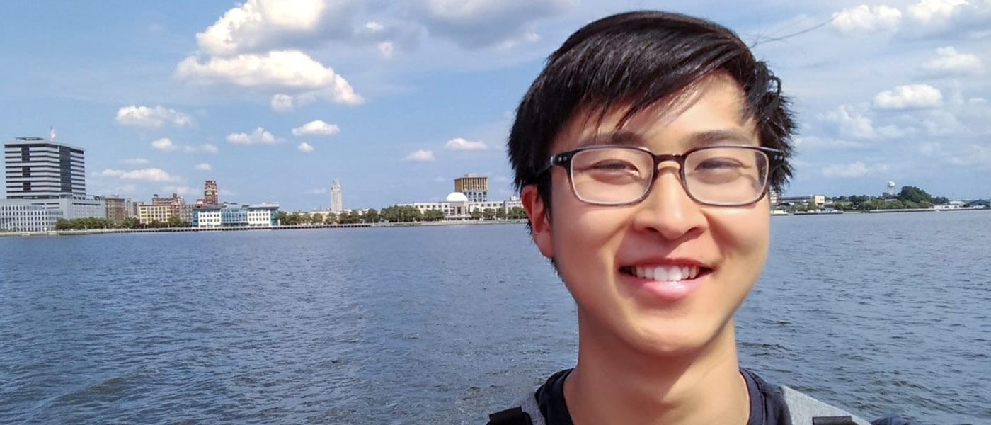 Selfie photo of Daniel Shao in front of a body of water