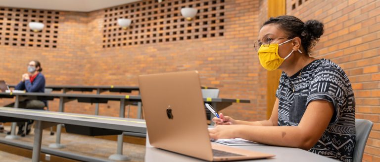 Photo of a masked student in class