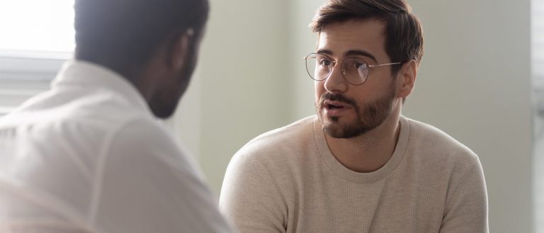 Photo of a man talking to a doctor