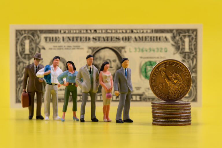 A line of multi-colored plastic various figures of people to a 1 USD coin standing on the edge in front of a 1 USD bill on a yellow background