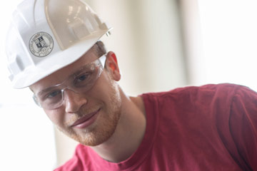 Photo of Luke Traverso wearing a hard hat and safety glasses