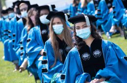 Photo of School of Medicine graduates seated in a line