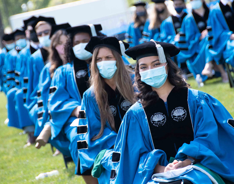 Photo of School of Medicine graduates seated in a line