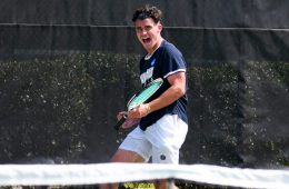 Photo of CWRU men's tennis player celebrating during a match