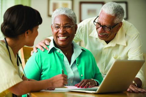 African American elderly couple in front of a laptop