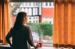 Photo of a woman looking out a window