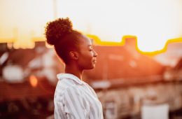 Young African American woman is relaxing on the rooftop