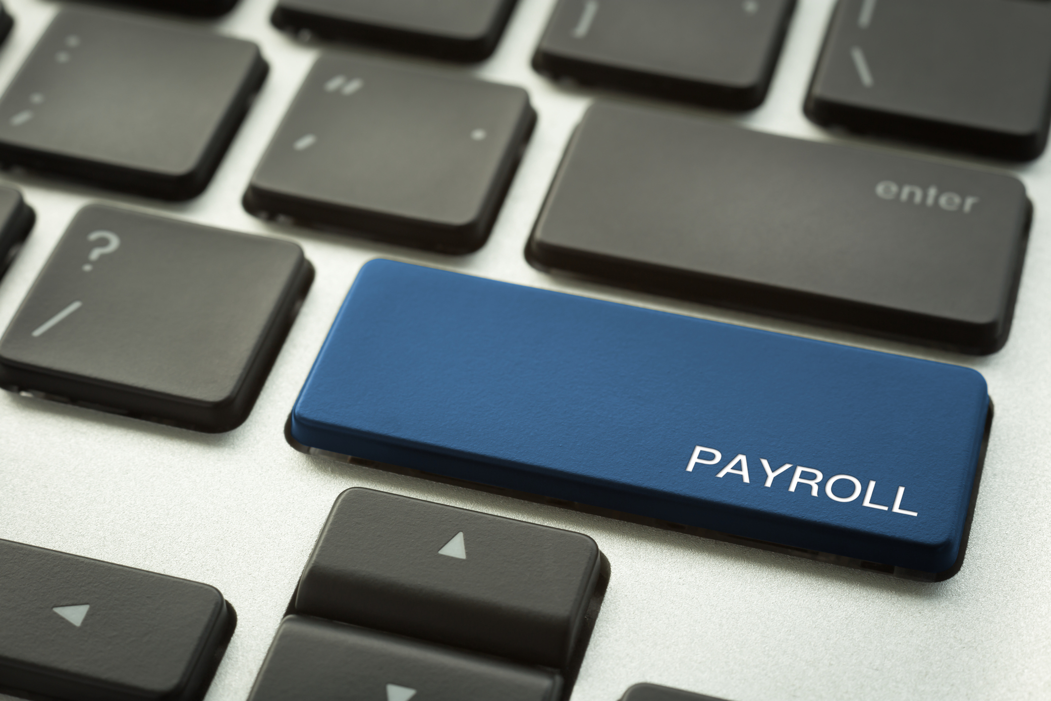 Laptop keyboard button with word PAYROLL.