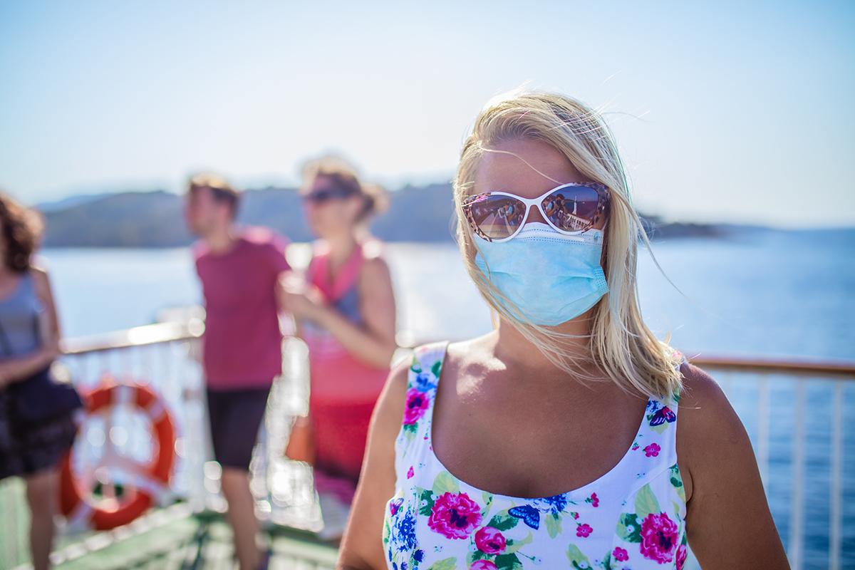 Woman on cruise ship with protective face mask