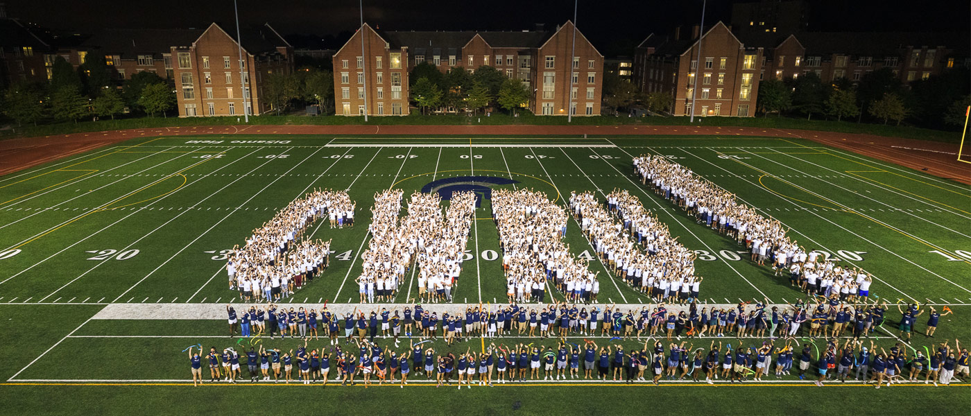 Photo of the CWRU Class of 2025 spelling out "CWRU!" on Disanto Field