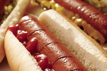 Close up photo on hotdogs with condiments on them