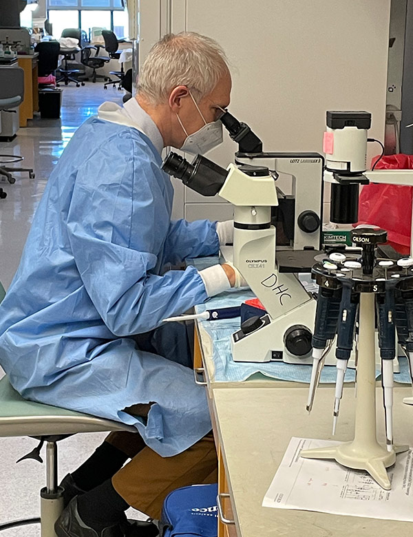 David Canaday looks at cells under a microscope. 