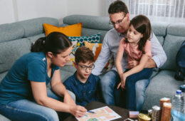 Photo of a family of four gathered around a table going over their emergency plan