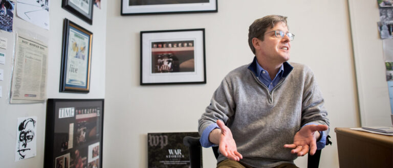 Photo of Jim Sheeler talking in his office