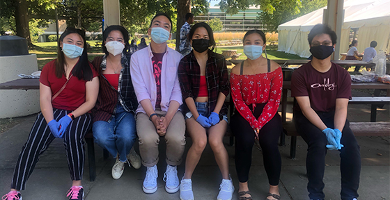 Filipino students sitting outside together and wearing masks