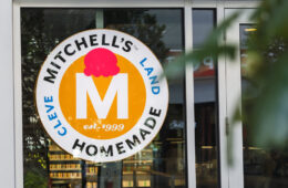 Photo of the Mitchell's Ice Cream sign in the window of its Uptown location