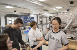 Photo of CWRU students working on a robotics project at Sears think[box]