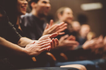 Photo of an audience clapping