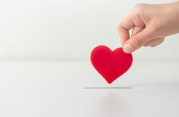 Photo of a hand holding a heart-shaped object