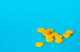 Yellow pillss on a blue table