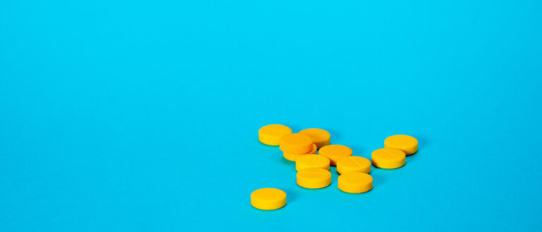 Yellow pillss on a blue table