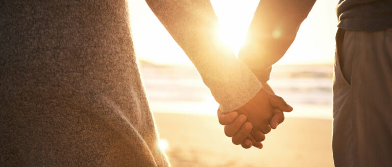 Photo of two people holding hands