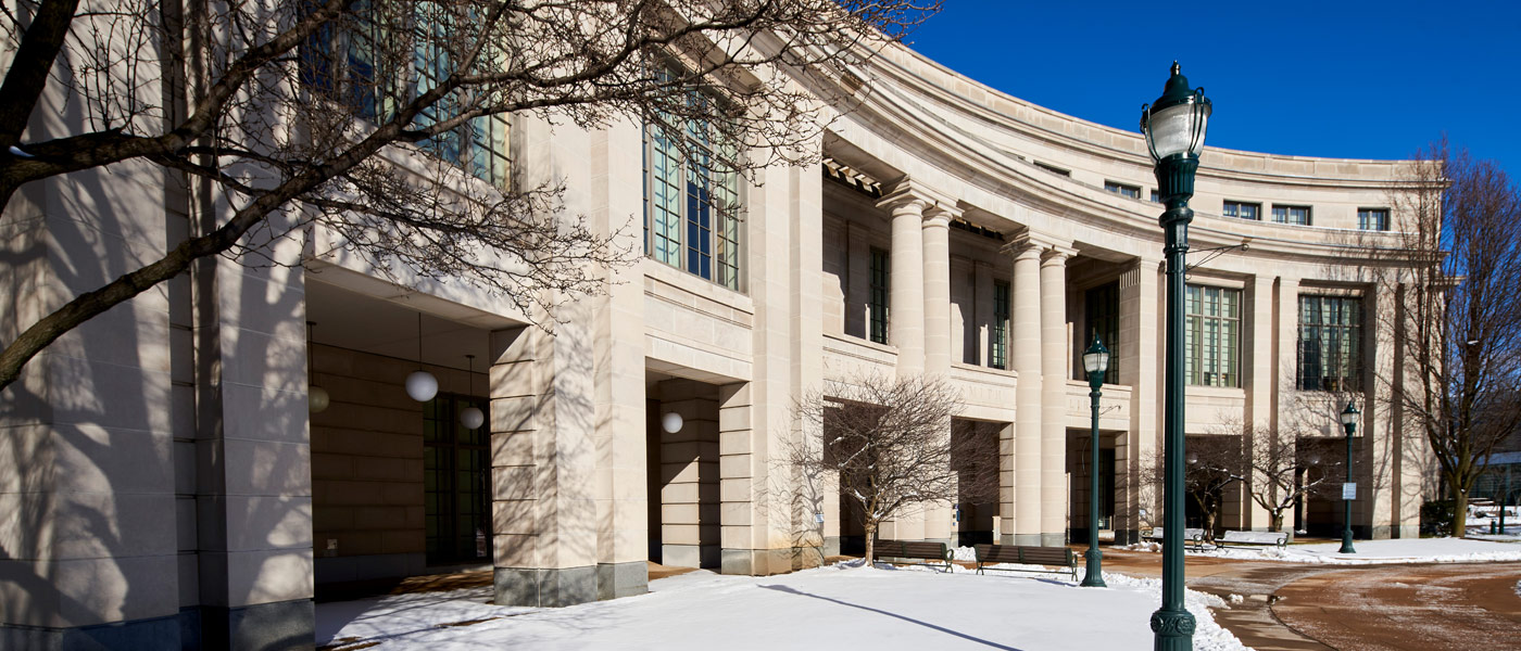 Photo of the exterior of Kelvin Smith Library with snow on the ground in front of it and blue skies overhead