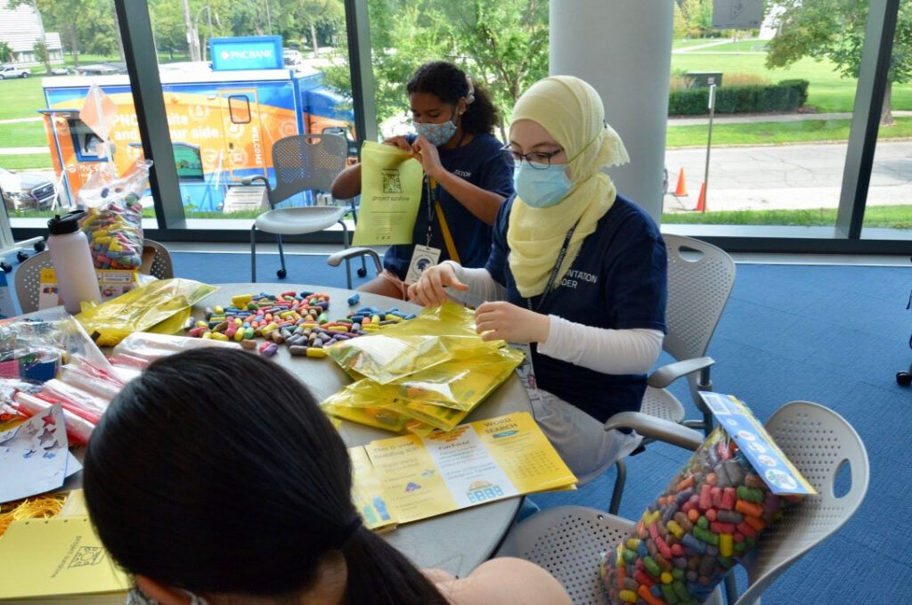 Photo of students in Project Sunshine preparing care packages for children