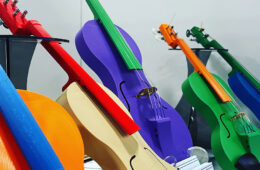 Image of several multi-colored violins