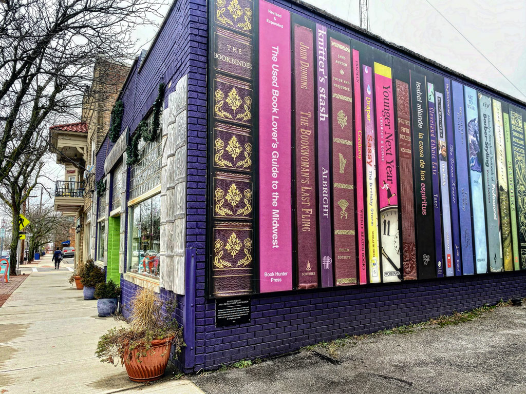 Photo of the exterior of Loganberry Books with painted book bindings on the wall