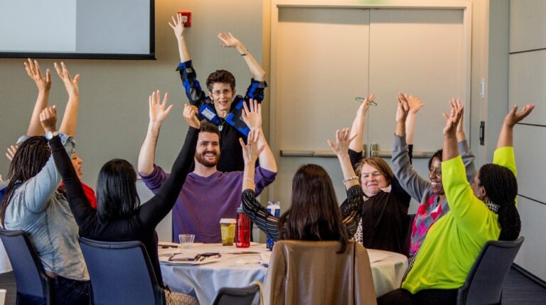 Members of the CWRU community with their hands in the air during a Diversity 360 workshop