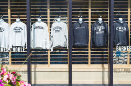 Photo of the front window of the CWRU bookstore showing CWRU gear