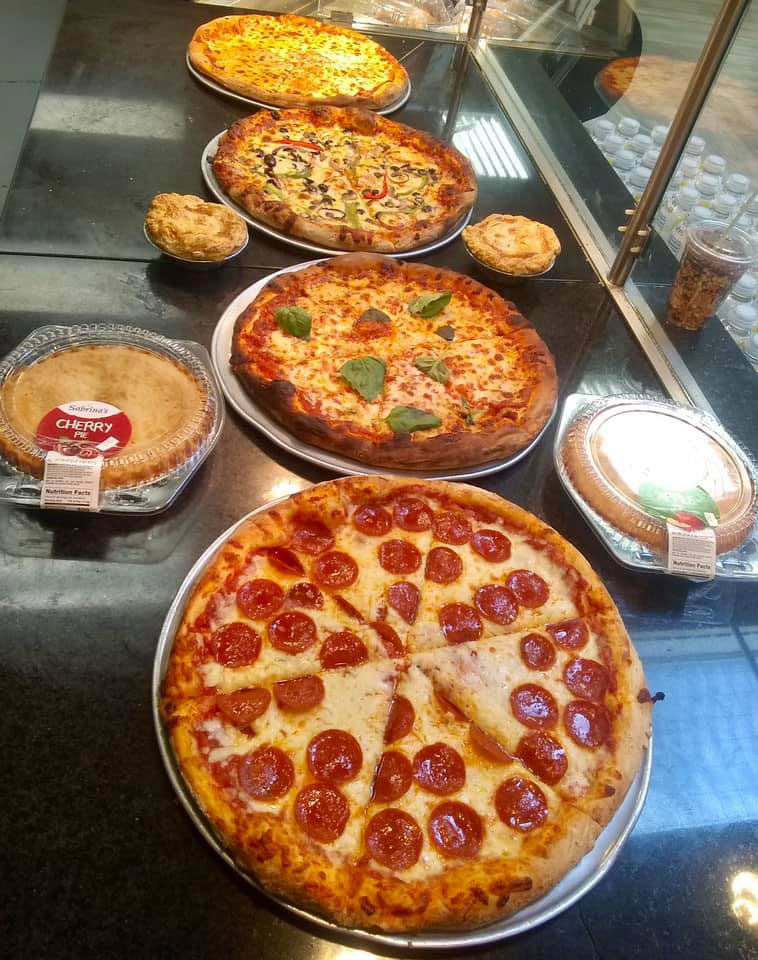 Photo of Edison's pizzas lined up on a counter