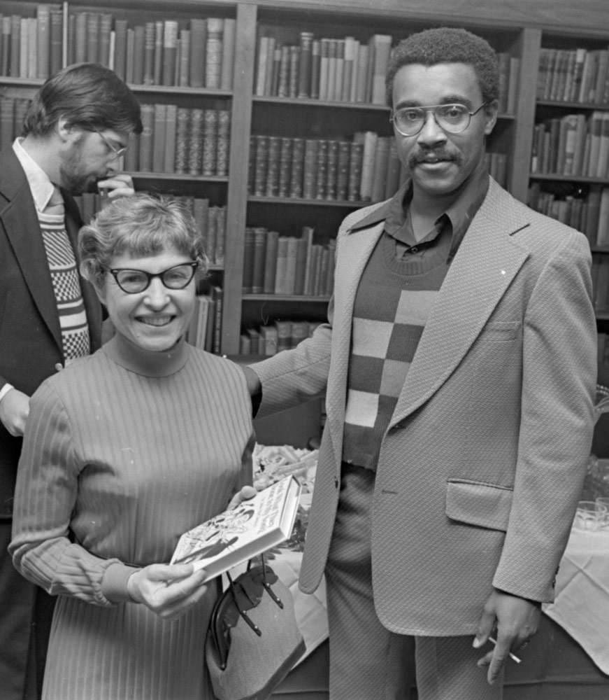 Photo of John A. McCluskey posing for a photo with a woman at a book reception in Tomlinson Hall