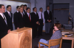 Photo of students in the Case Men's Glee Club singing in a class in 1998