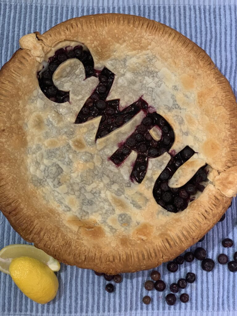 Blueberry pie with CWRU letters baked into the crust