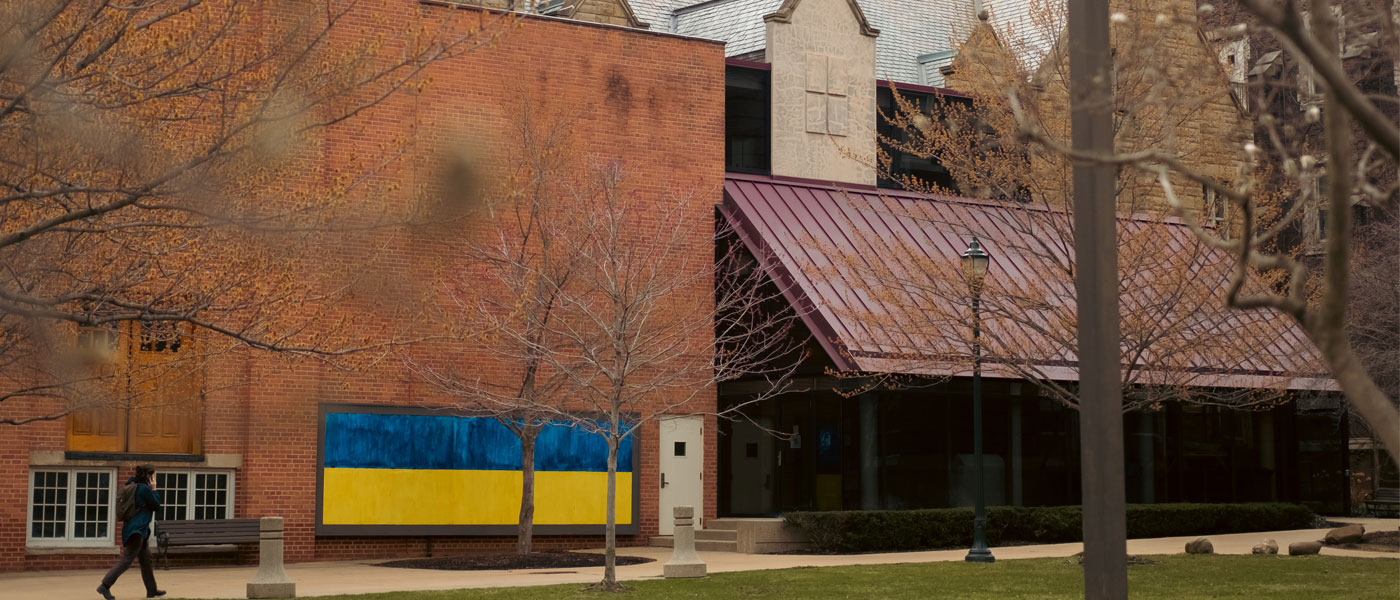 Photo of a building on Case Quad at Case Western Reserve at night, with a blue and yellow Ukraine flag mural painted on its side