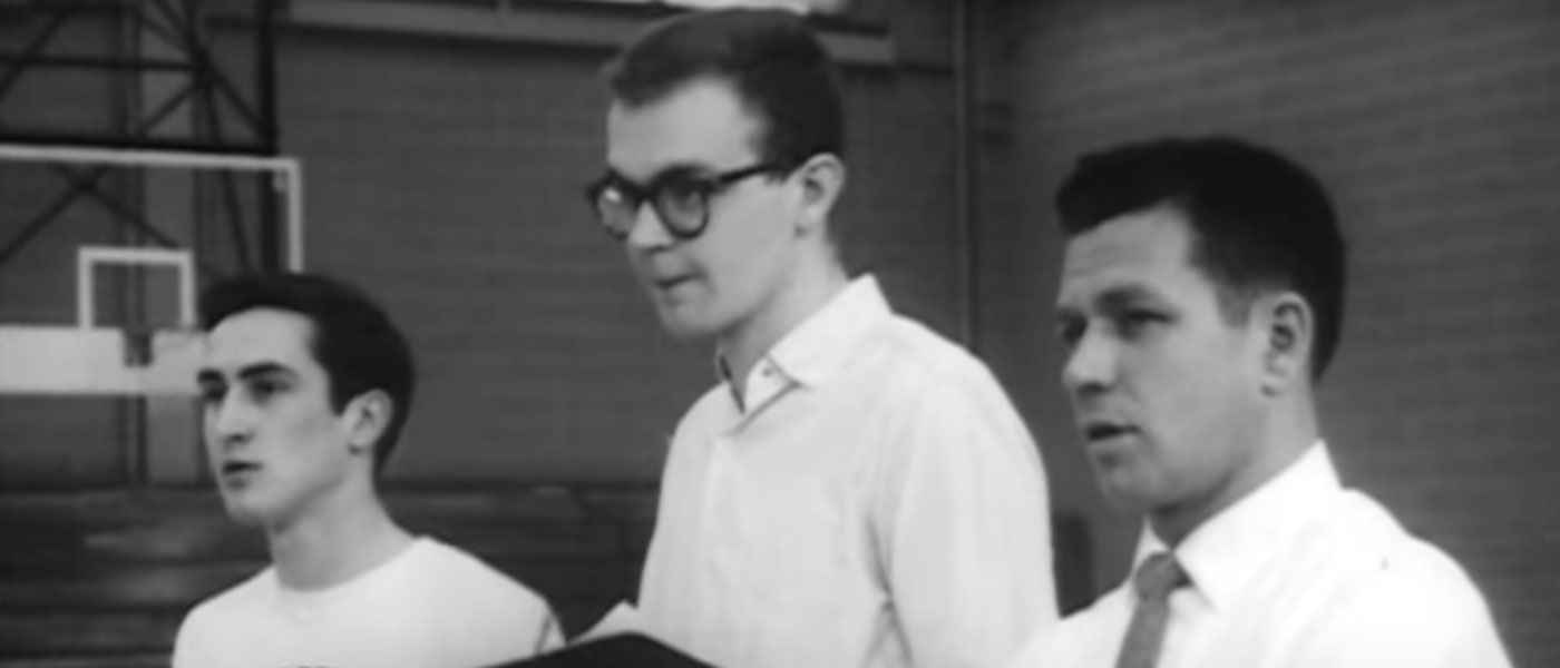 Black and white photo of Case Institute of Technology student Donald Knuth standing with a basketball player and coach