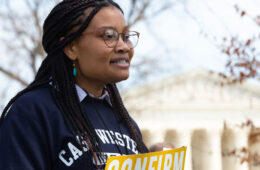 Photo of Case Western Reserve University student Makela Hayford giving a speech outdoors in front of the Supreme Court building