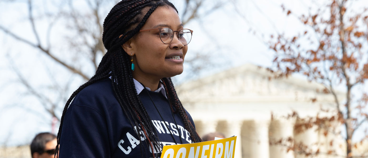 Photo of Case Western Reserve University student Makela Hayford giving a speech outdoors in front of the Supreme Court building