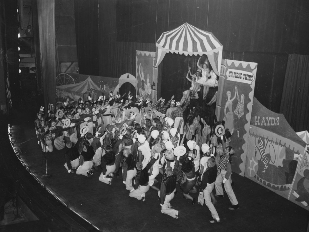 A black and white photo of a Mather College for Women Stunt Night, showing a stage that appears to be a circus