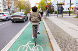 Cyclist in city traffic using the bicycle lane