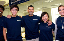 CWRU student volunteers pose in matching t-shirts at the Center for International Affairs' grand opening in 2011