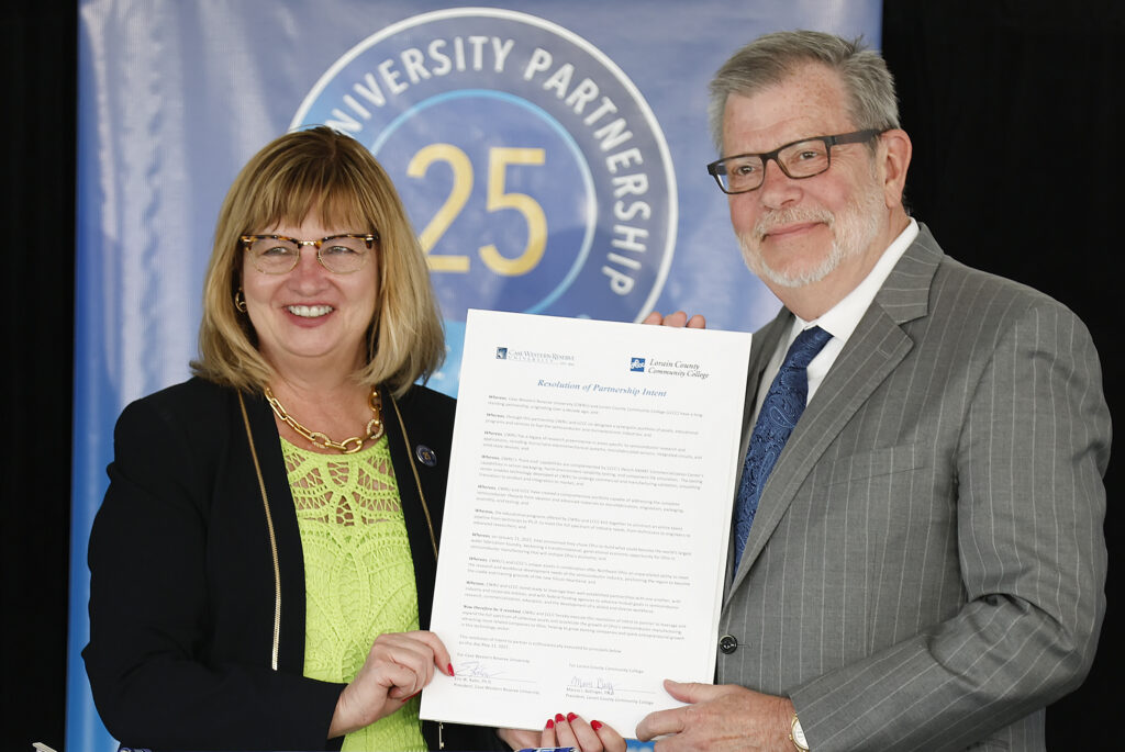 LCCC President Marcia J. Ballinger and Case Western Reserve University President Eric W. Kaler show off the signed Resolution of Partnership Intent. 