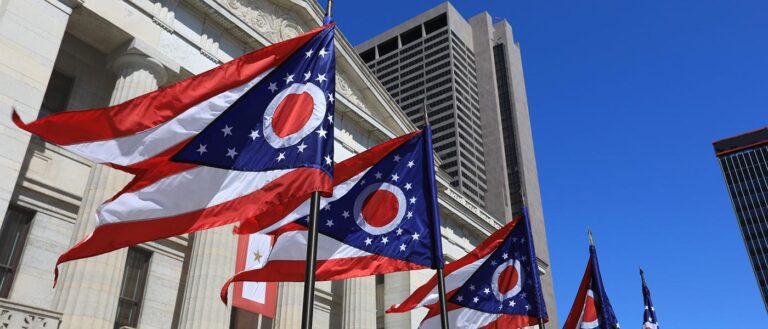 State of Ohio flags waving in front of the Statehouse in Columbus, OG.