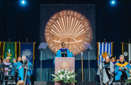Photo of the stage at Case Western Reserve University commencement with Cleveland Mayor Justin Bibb speaking at a podium