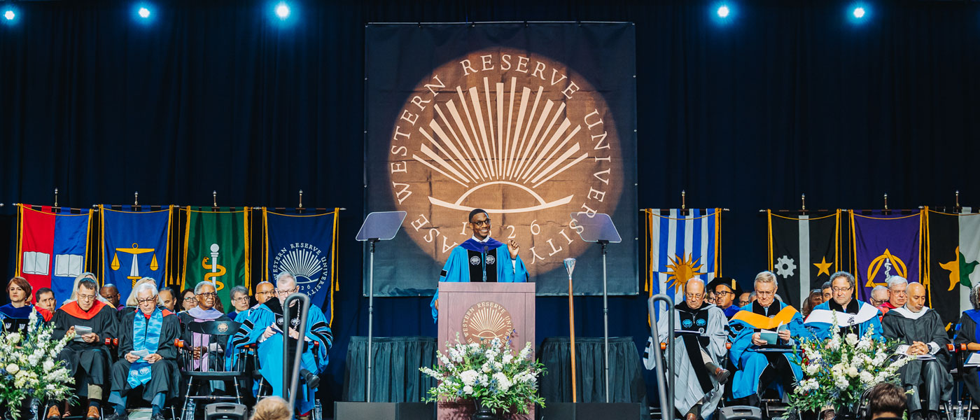 Photo of the stage at Case Western Reserve University commencement with Cleveland Mayor Justin Bibb speaking at a podium